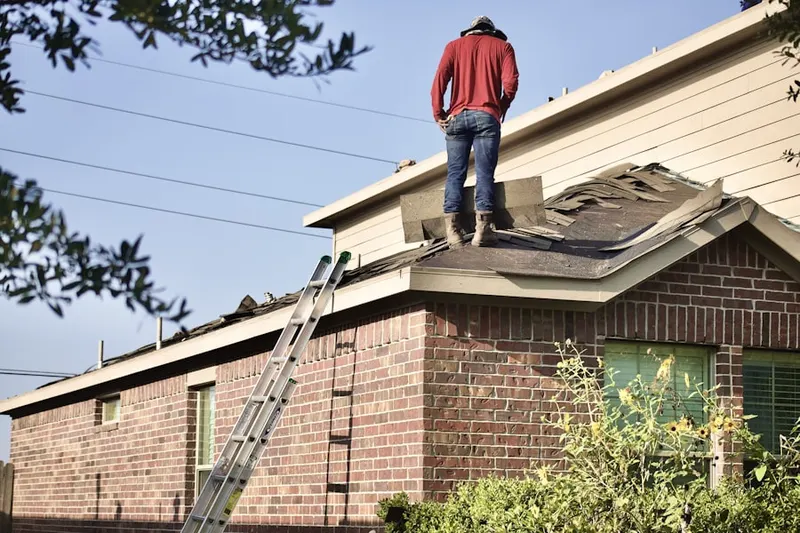 Professional roofer working on a residential roof in San Benito
